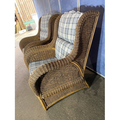 396 - Two good quality wicker conservatory arm chairs.