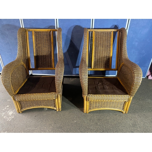 396 - Two good quality wicker conservatory arm chairs.