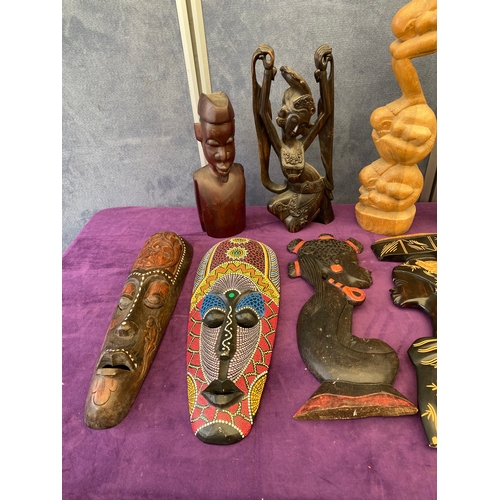 446 - A selection of carved wooden African ornaments and African masks.