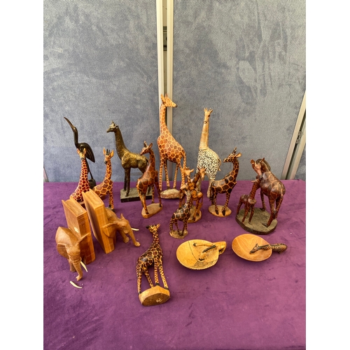 450 - Quantity of wooden Giraffe ornaments, Elephant book ends.