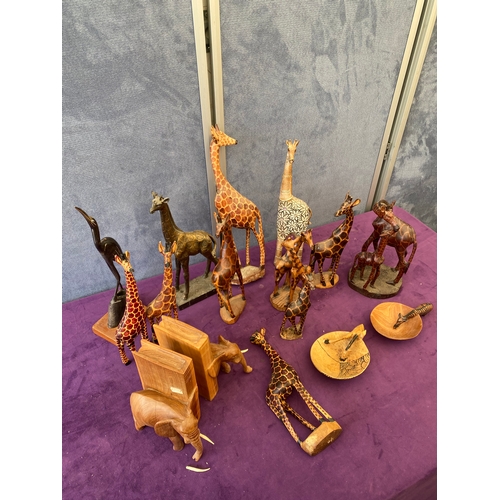 450 - Quantity of wooden Giraffe ornaments, Elephant book ends.