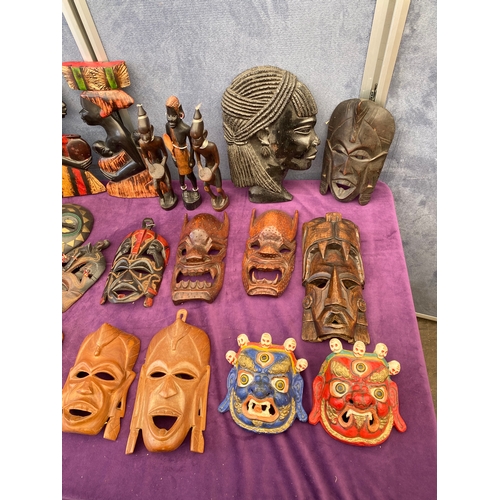 452 - A large collection of African tribal masks/ wall art and ornaments - last quarter 20th century