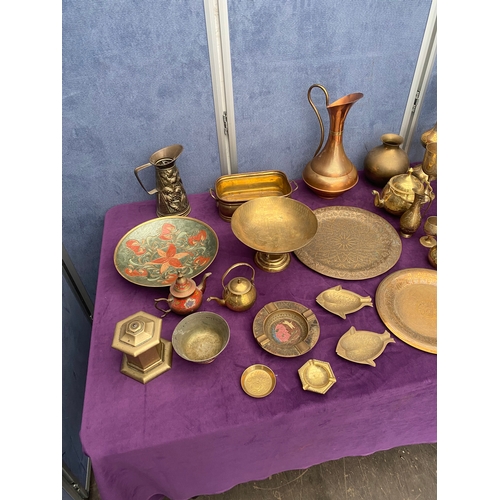 456 - Large quantity of brass collectables including teapots, pourers, plates and jugs.