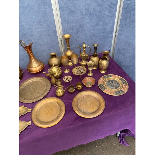 456 - Large quantity of brass collectables including teapots, pourers, plates and jugs.