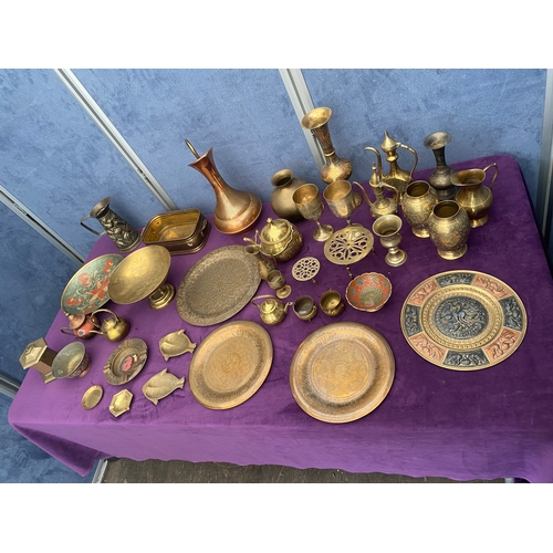 456 - Large quantity of brass collectables including teapots, pourers, plates and jugs.