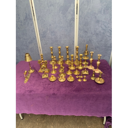 457 - A large quantity of brass candlestick holders.