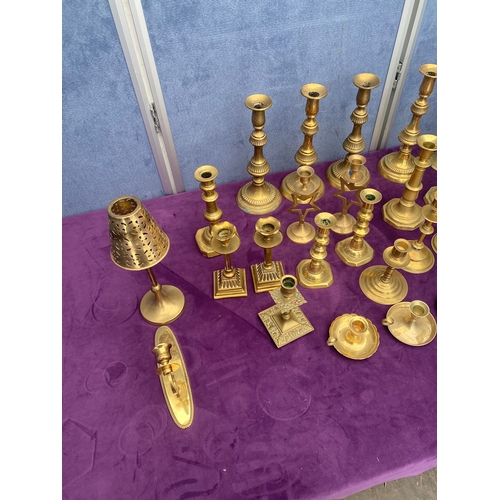 457 - A large quantity of brass candlestick holders.