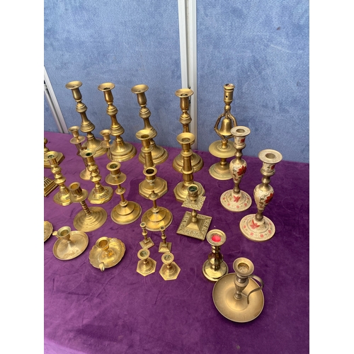 457 - A large quantity of brass candlestick holders.