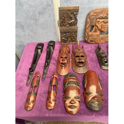 460 - Quantity of carved wooden African tribal wall art and masks.