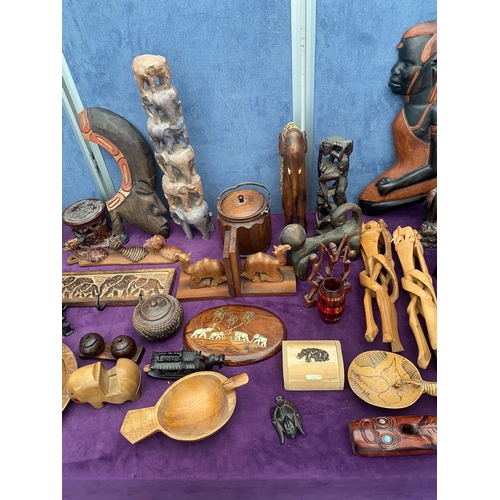 461 - A collection of carved wooden collectables, wall art, statues.