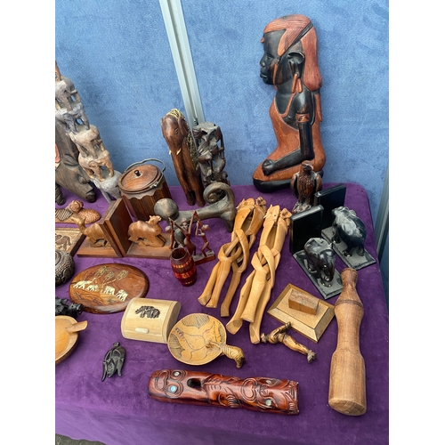 461 - A collection of carved wooden collectables, wall art, statues.