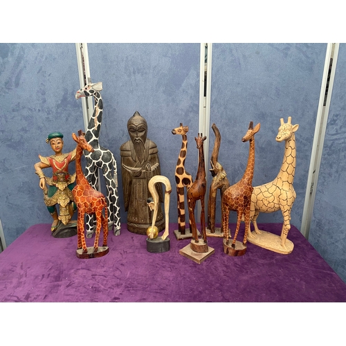 465 - A lot of wooden African / Asian statues including Giraffes.