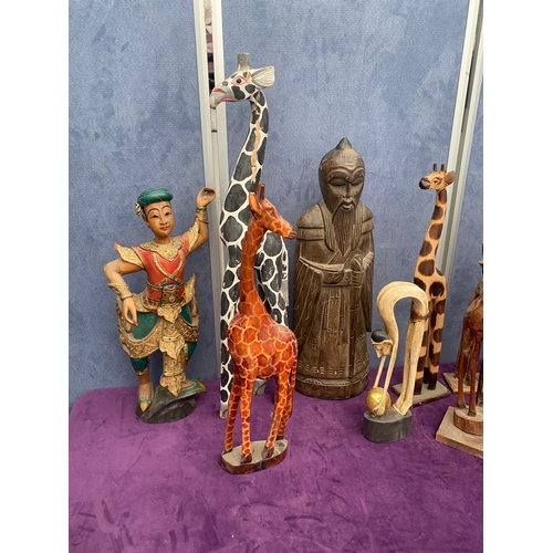 465 - A lot of wooden African / Asian statues including Giraffes.