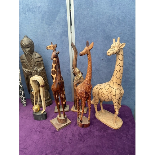 465 - A lot of wooden African / Asian statues including Giraffes.