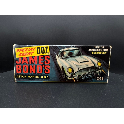 143 - Corgi Toys 261 James Bond Aston Martin D.B.5 in original box, plinth & instructions