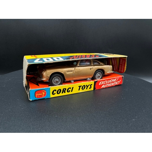 143 - Corgi Toys 261 James Bond Aston Martin D.B.5 in original box, plinth & instructions