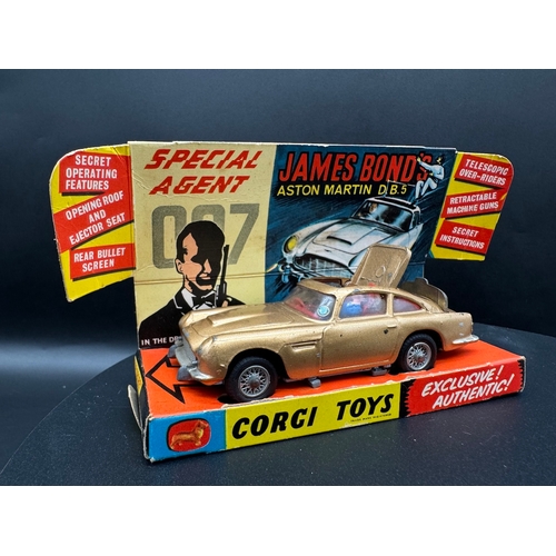 143 - Corgi Toys 261 James Bond Aston Martin D.B.5 in original box, plinth & instructions