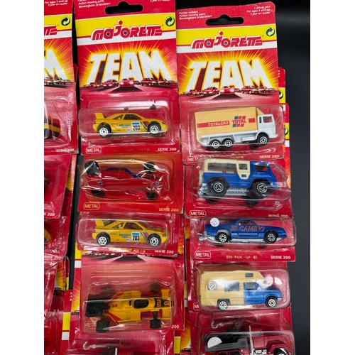 164 - A collection of 23 Majorette Team Serie 200 Diecast Model Cars / Vehicles all carded