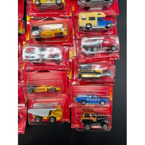 164 - A collection of 23 Majorette Team Serie 200 Diecast Model Cars / Vehicles all carded