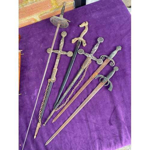 106 - A selection of decorative swords / daggers