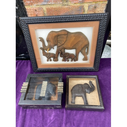 115 - Three framed wooden carved elephants.