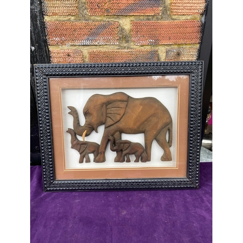 115 - Three framed wooden carved elephants.