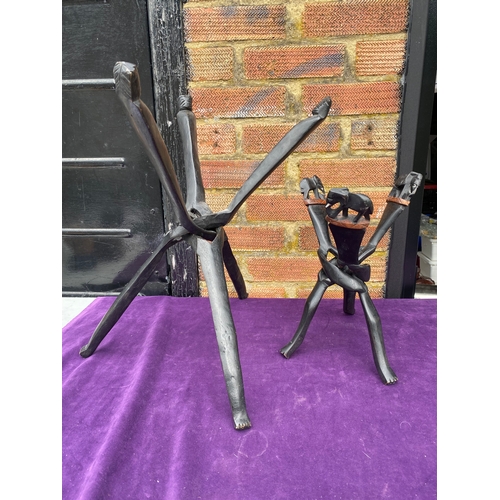 132 - Two wooden carved tripod stands.