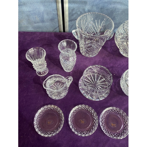 230 - A collection of crystal vases and place matts including Harrods