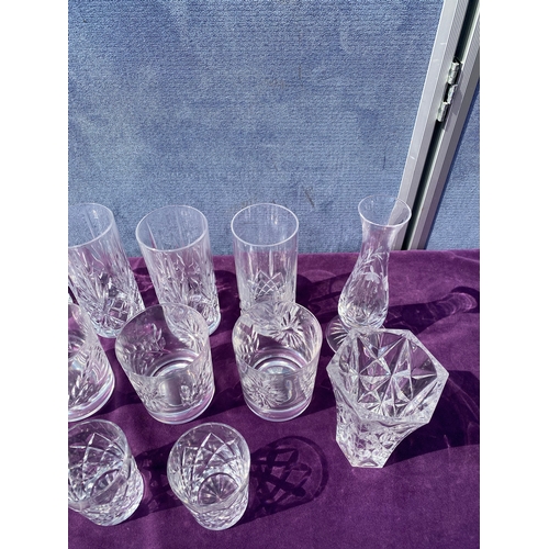 83 - A collection of crystal drinking glasses, bells and two small vases