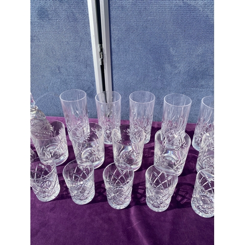 83 - A collection of crystal drinking glasses, bells and two small vases