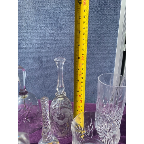 83 - A collection of crystal drinking glasses, bells and two small vases