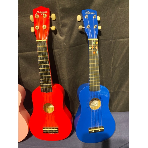 223 - A colourful collection of four branded Ukuleles including Winzz, Kona, Martin Smith and Redwoods.