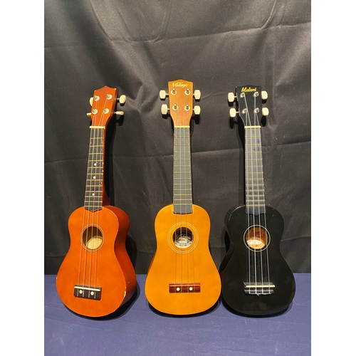 224 - Three Ukuleles including Vintage, Malani and C.Giant.