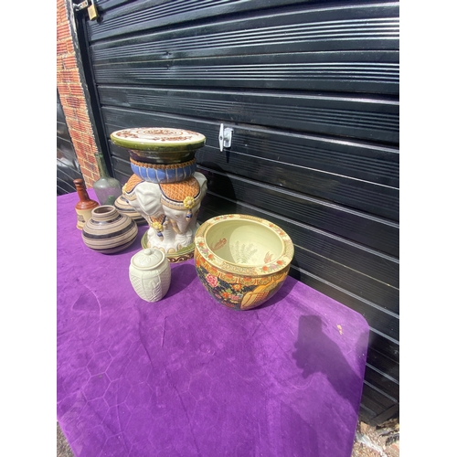 82 - A miscellaneous lot including Bells bottle, Elephant pot stand and some vases