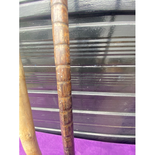 87 - A collection of walking sticks / canes and ceramic stick/umbrella holder.