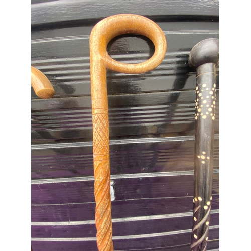 87 - A collection of walking sticks / canes and ceramic stick/umbrella holder.