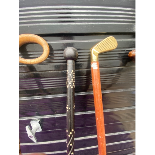 87 - A collection of walking sticks / canes and ceramic stick/umbrella holder.