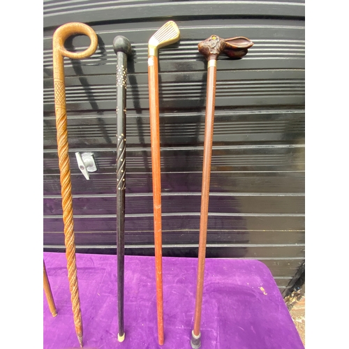 87 - A collection of walking sticks / canes and ceramic stick/umbrella holder.