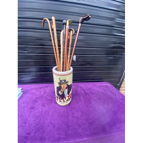 87 - A collection of walking sticks / canes and ceramic stick/umbrella holder.