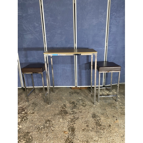 222 - A modern slimline chrome leg table and two stools.