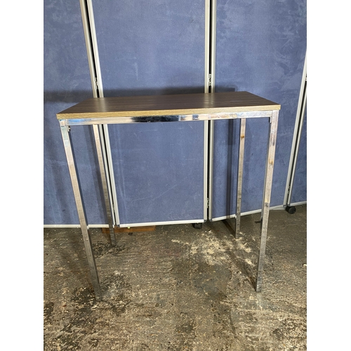 222 - A modern slimline chrome leg table and two stools.