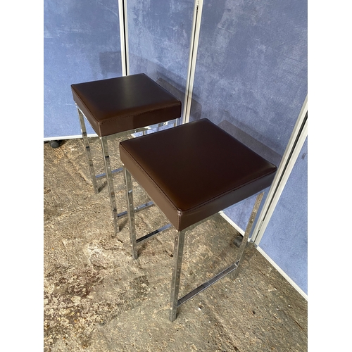 222 - A modern slimline chrome leg table and two stools.