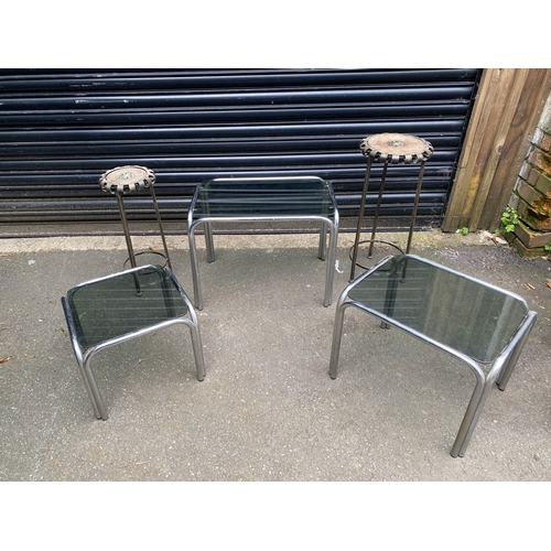 238 - A modern nest of three glass and chrome tables with A pair of metal plant stands.