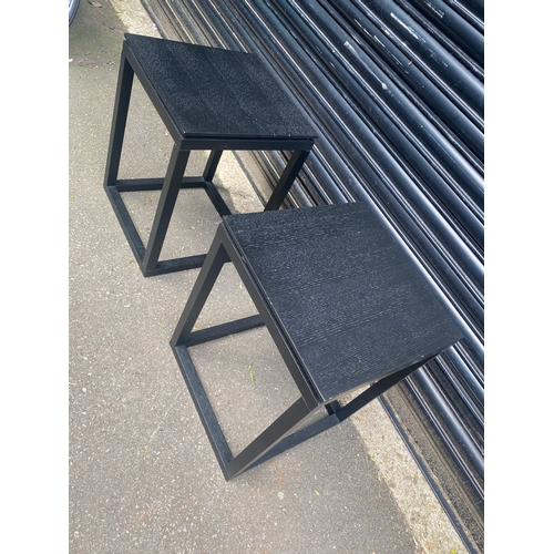 246 - A pair of ebonised wooden side tables.