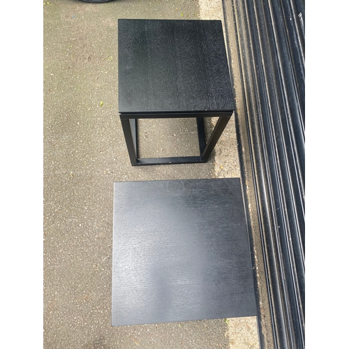 246 - A pair of ebonised wooden side tables.