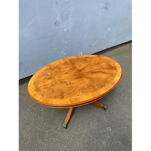 264 - Small oval inlaid tilt top coffee table.