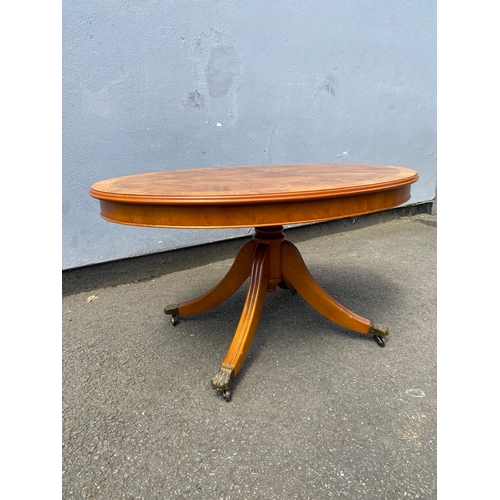 264 - Small oval inlaid tilt top coffee table.