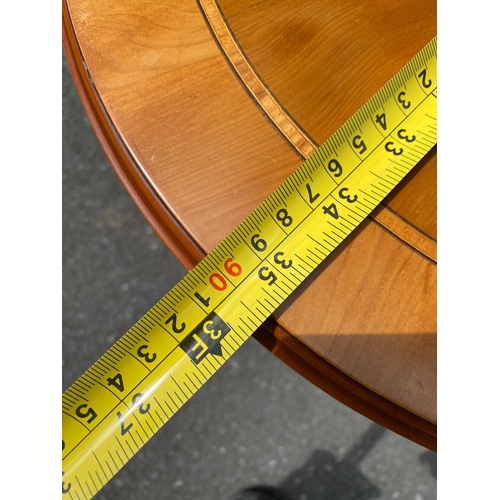 264 - Small oval inlaid tilt top coffee table.