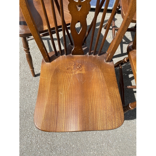 352 - Eight mahogany wheel back chairs including two carver style.