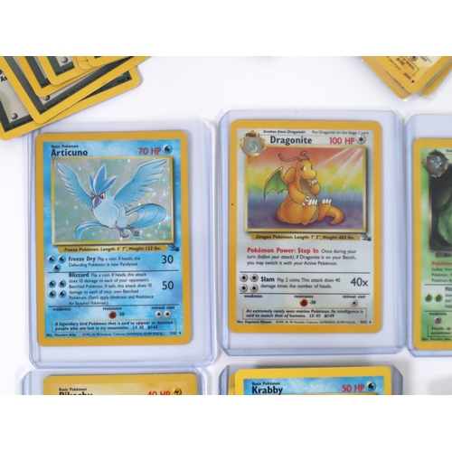 202 - Pokemon TCG - A group of 4 holographic cards from Fossil and Team Rocket Sets Articuno, Dragonite, D... 